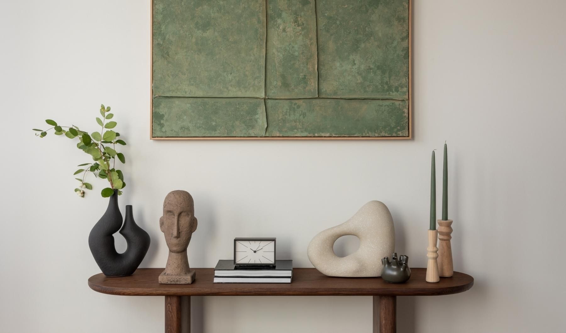 a clock and a vase on a table