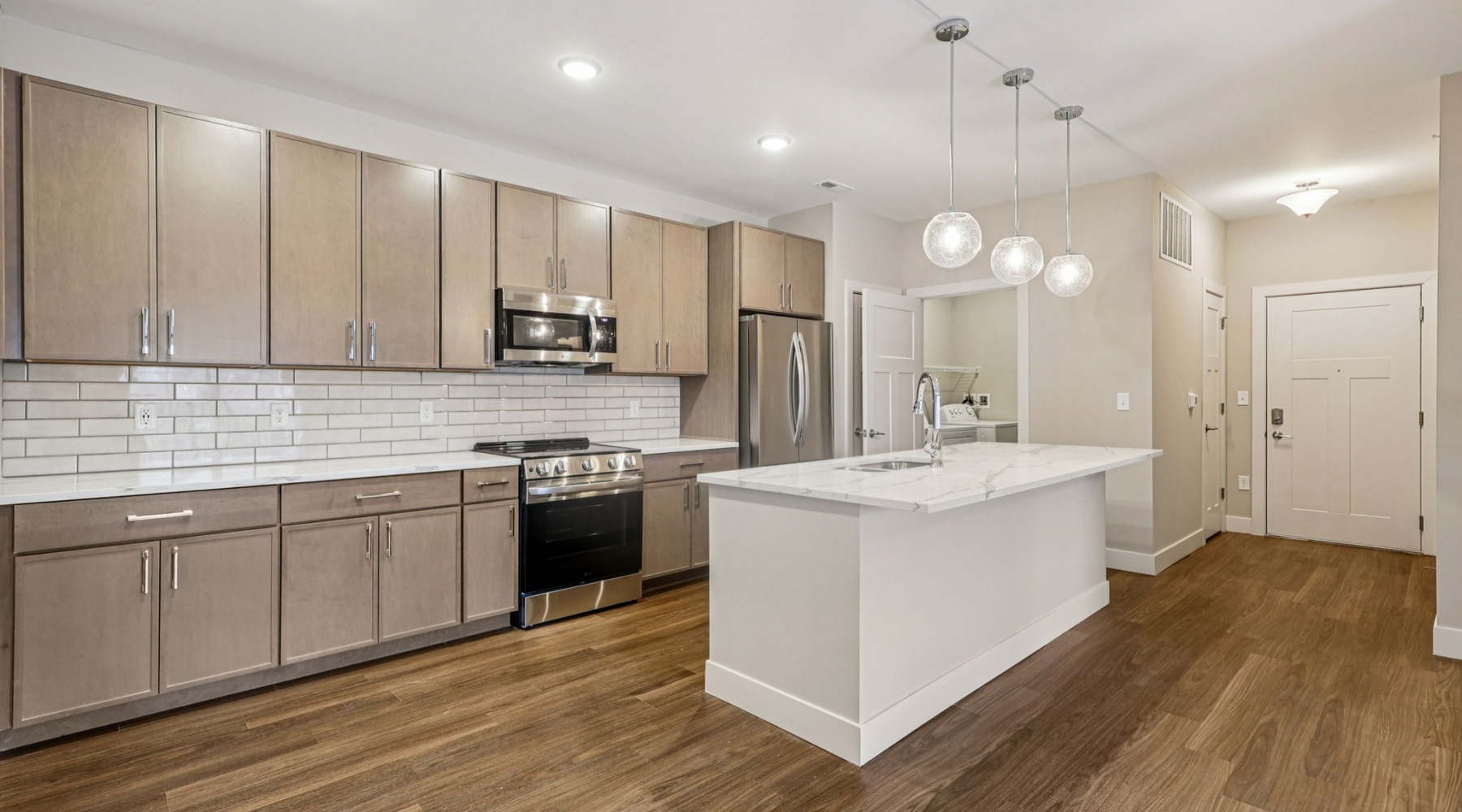 open space kitchen with white backsplash