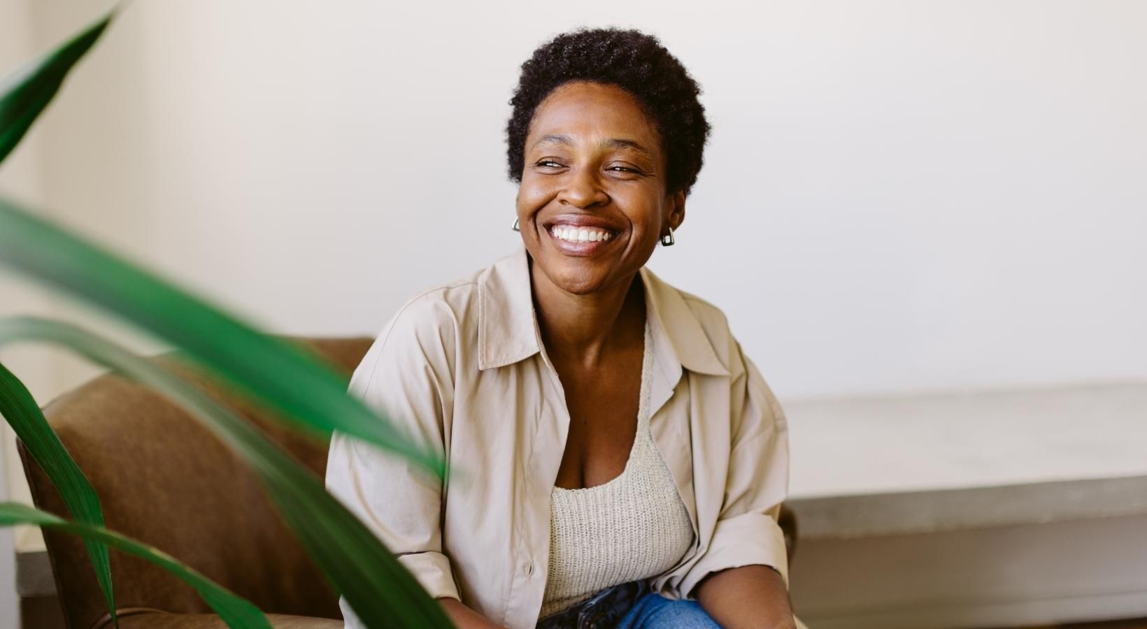 a person smiling and sitting in a chair