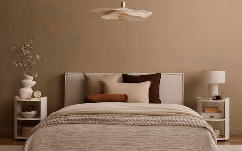 a bed with a lamp on the side