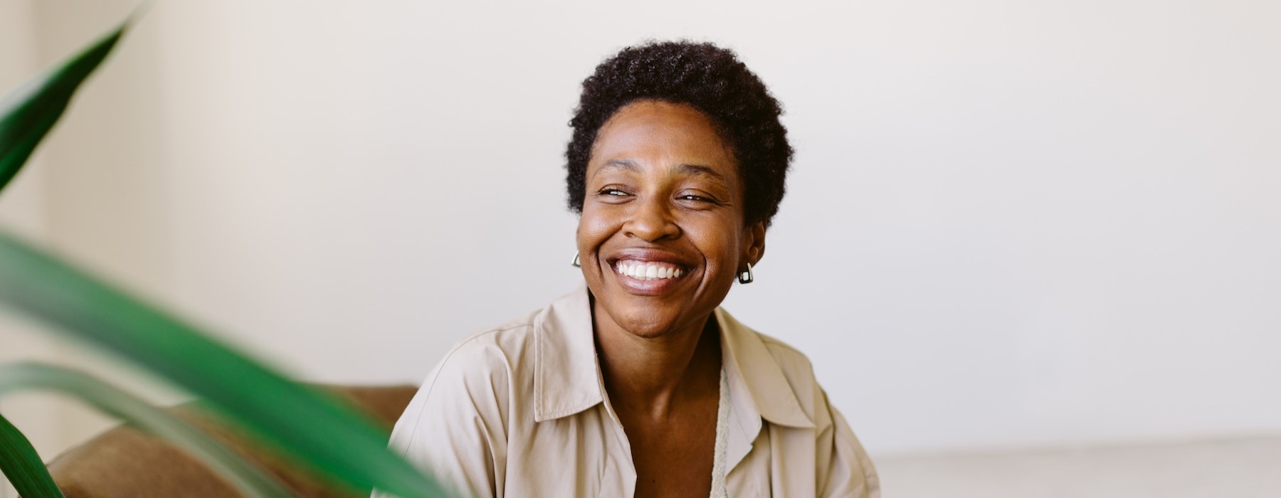 a person smiling and sitting in a chair