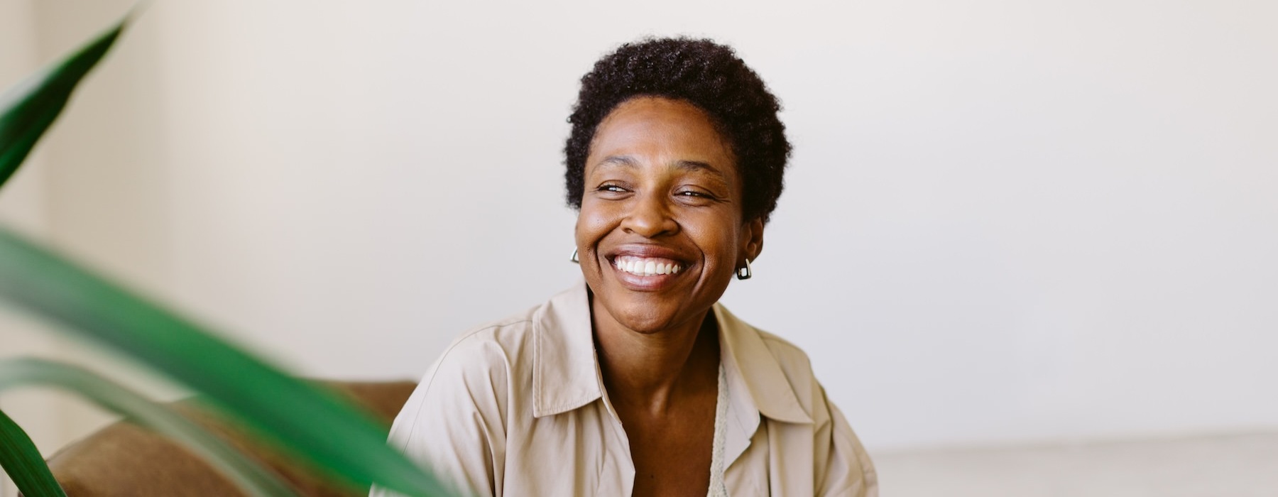 a person smiling and sitting in a chair